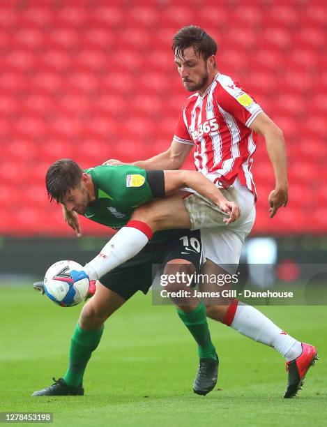 Morgan Fox of Stoke City tackles Lukas Jutkiewicz of Birmingham City during the Sky Bet Championship match between Stoke City and Birmingham City at...