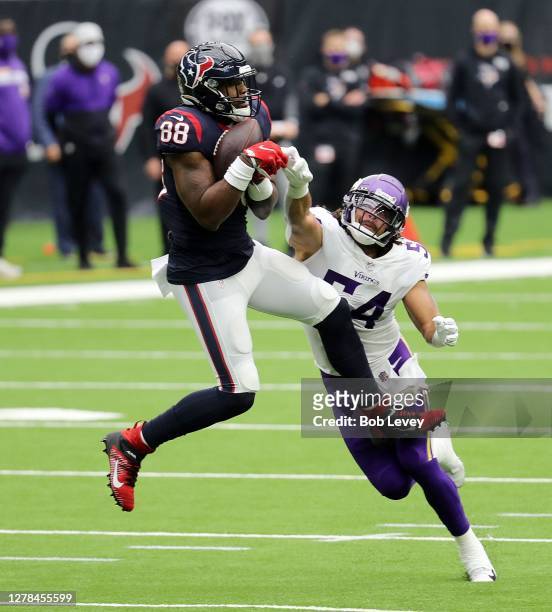 Jordan Akins of the Houston Texans makes a catch as Eric Kendricks of the Minnesota Vikings is in on the tackle during the second quarter at NRG...