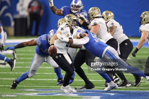 Drew Brees of the New Orleans Saints is sacked by Trey Flowers and Romeo Okwara of the Detroit LIons during the second quarter at Ford Field on...