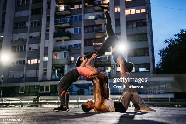 acroyoga outdoors - acrobatics gymnastics stock pictures, royalty-free photos & images