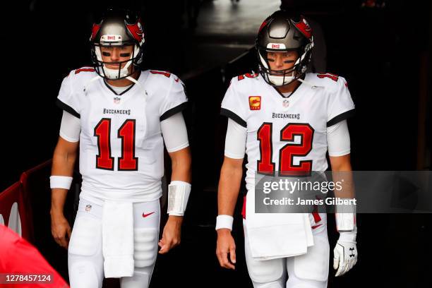 Tom Brady of the Tampa Bay Buccaneers and Blaine Gabbert of the Tampa Bay Buccaneers enter the field before the start of a game against the Los...