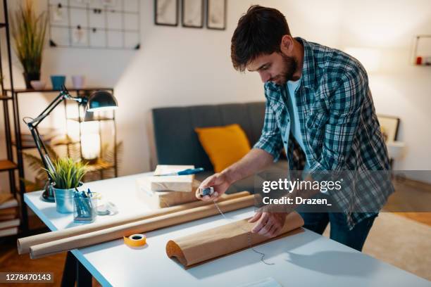 side hustle - man packing and sending second hand electric items - sole proprietorship stock pictures, royalty-free photos & images