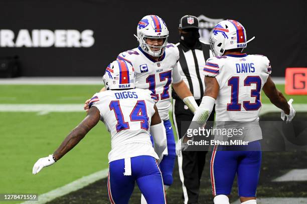 Josh Allen of the Buffalo Bills celebrates with Gabriel Davis and Stefon Diggs after Davis caught a 26-yard touchdown pass from Allen against the Las...