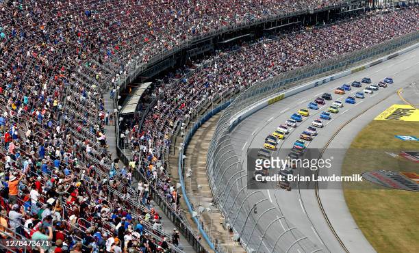Fans cheer as cars race during the NASCAR Cup Series YellaWood 500 at Talladega Superspeedway on October 04, 2020 in Talladega, Alabama.
