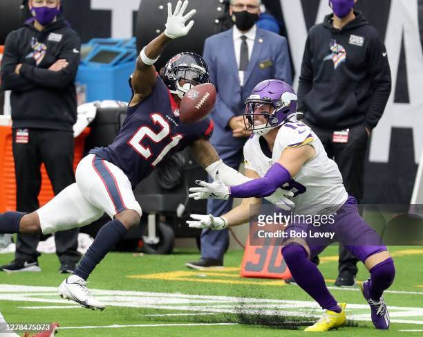 Adam Thielen of the Minnesota Vikings is unable to hold onto the ball as Bradley Roby of the Houston Texans defends during the second half at NRG...