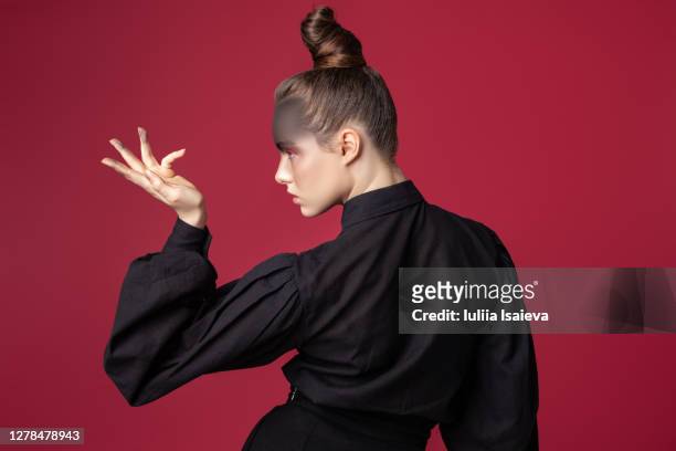 charming woman on red background in studio - beauty cosmetic luxury studio background stock-fotos und bilder