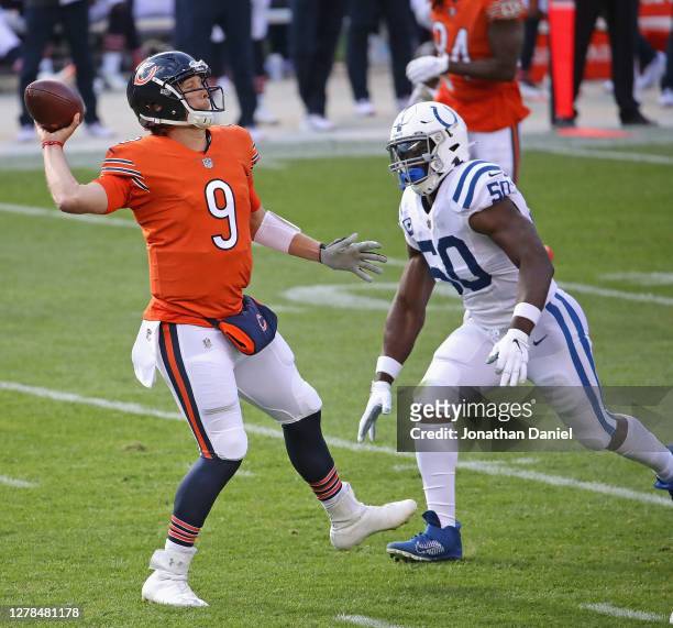 Nick Foles of the Chicago Bears passes under pressure from Justin Houston of the Indianapolis Colts at Soldier Field on October 04, 2020 in Chicago,...