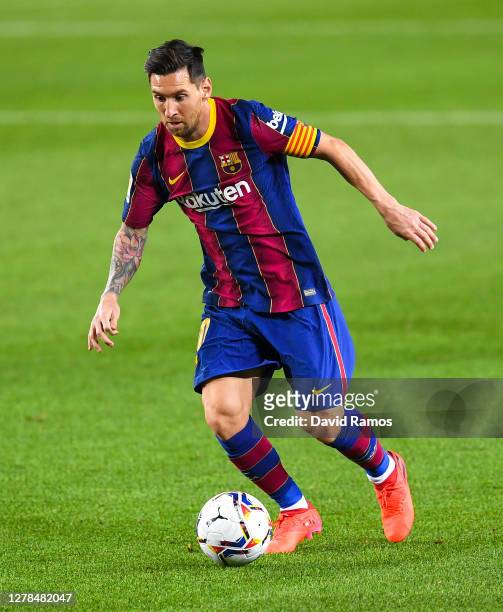 Lionel Messi of FC Barcelona runs with the ball during the La Liga Santander match between FC Barcelona and Sevilla FC at Camp Nou on October 04,...