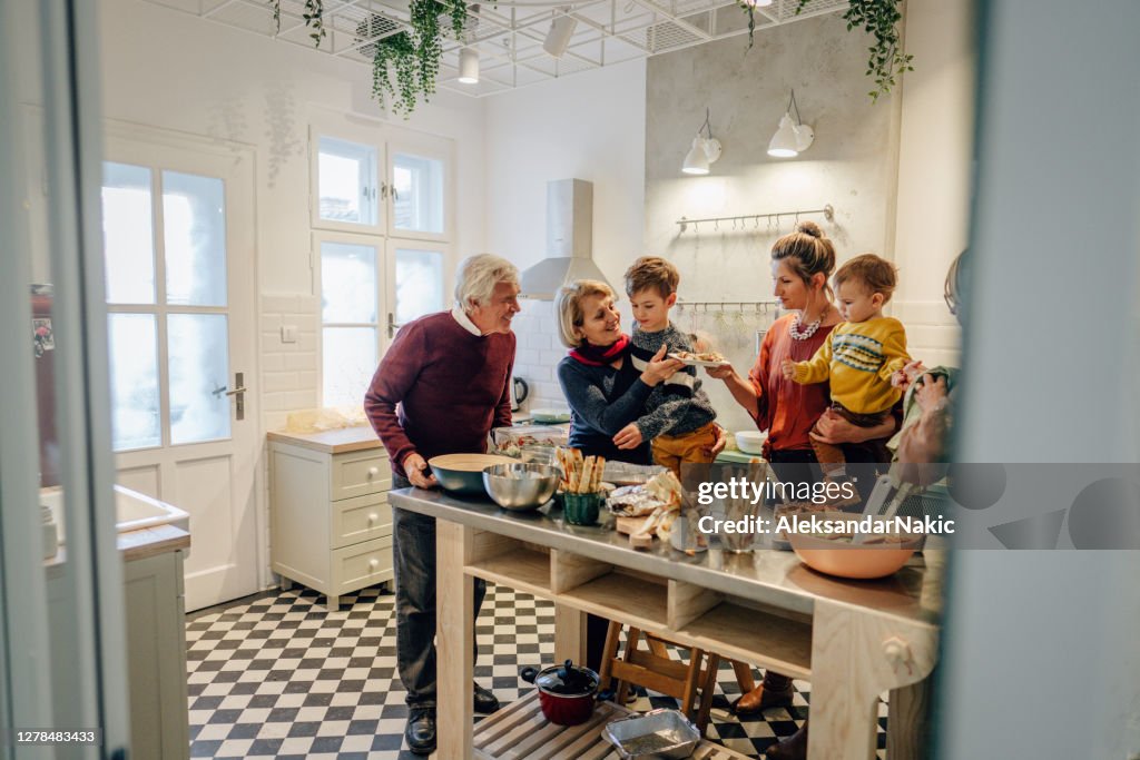 Familia preparando la cena de Acción de Gracias en la cocina