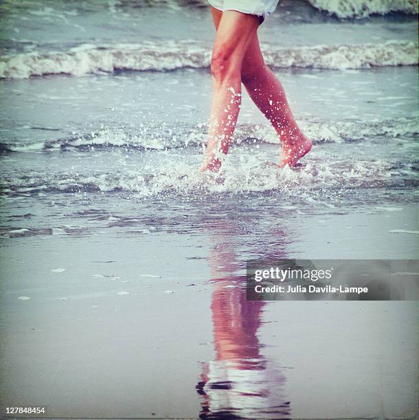 woman walking in water at seashore - norderney imagens e fotografias de stock