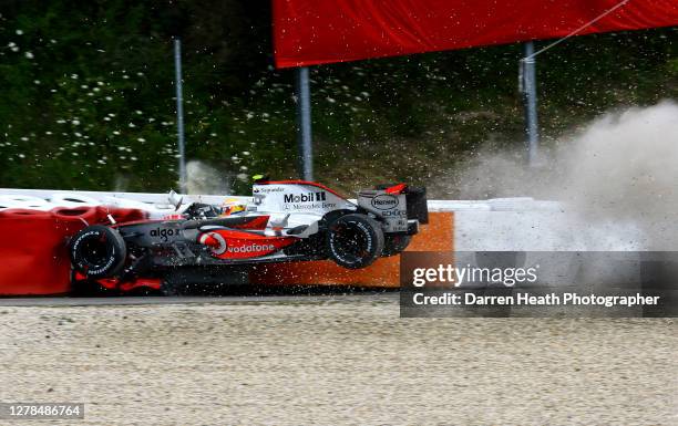 British McLaren Formula One driver Lewis Hamilton crashes in to the barriers at high speed after losing control of his MP4-22 car during practice for...