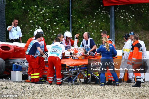 British McLaren Formula One driver Lewis Hamilton is stretchered away from his crashed McLaren MP4-22 car during practice for the 2007 European Grand...