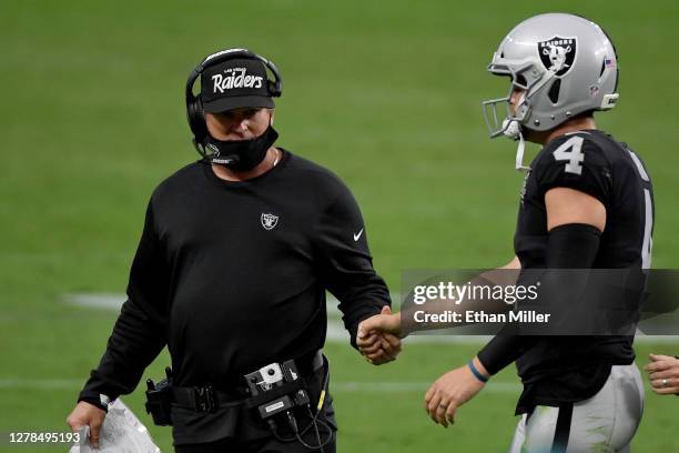 Head coach Jon Gruden shakes hands with Derek Carr of the Las Vegas Raiders against the Buffalo Bills during the fourth quarter in the game at...