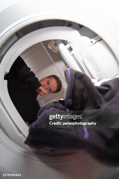 dropping underwear down into a washing machine - shorts down stock pictures, royalty-free photos & images