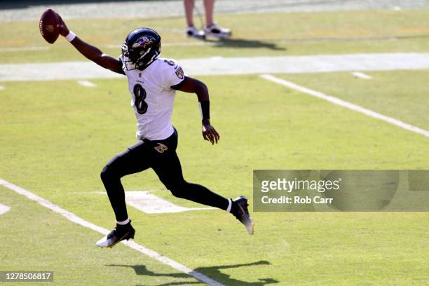 Quarterback Lamar Jackson of the Baltimore Ravens celebrates while rushing for a touchdown against the Washington Football Team while rushing for a...