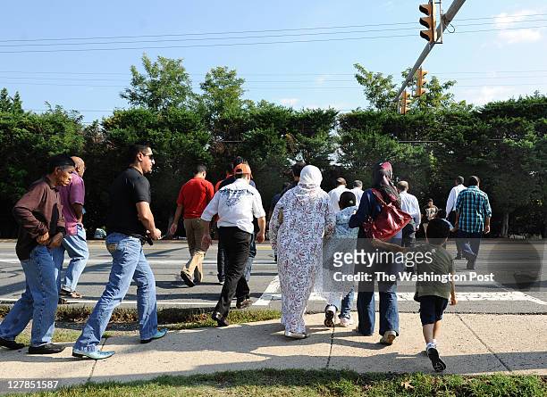 Folks cross Route 7 en route to Dar al-Hijrah Mosque before midday Friday prayers on September 30 in Falls Church, VA. U.S.-born al-Qaeda leader...
