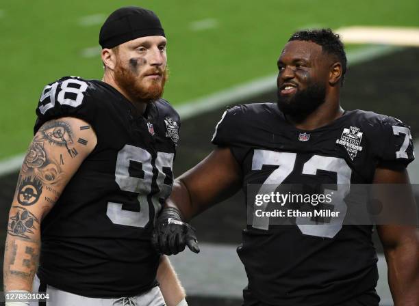 Defensive end Maxx Crosby and defensive tackle Maurice Hurst of the Las Vegas Raiders walk off the field after the team's 30-23 loss to the Buffalo...