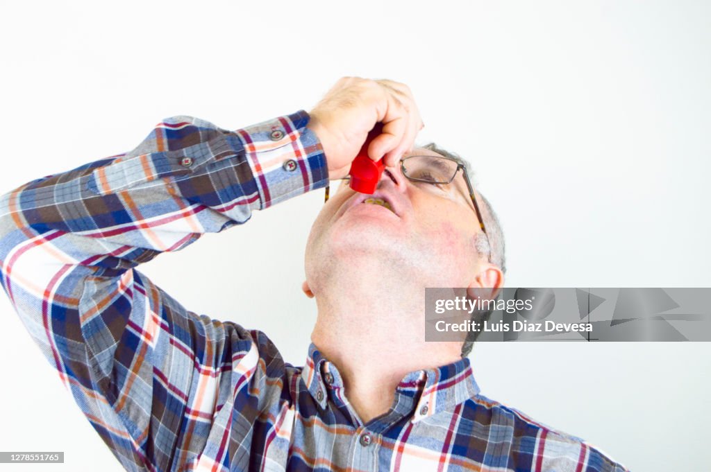 Person Using An Inhaler Person Using Asthma Inhaler High-Res Stock Photo - Getty Images