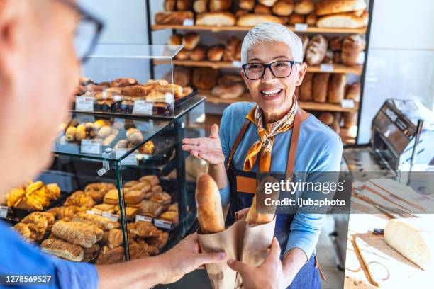 you won't find bread and service quite as good elsewhere - man offering bread stock pictures, royalty-free photos & images