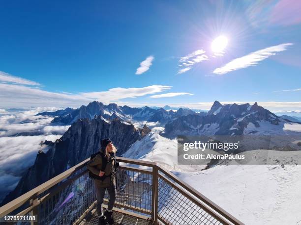 woman looking at view from aiguille du midi. chamonix needles, mont blanc, haute-savoie, alps, france - aiguille de midi imagens e fotografias de stock