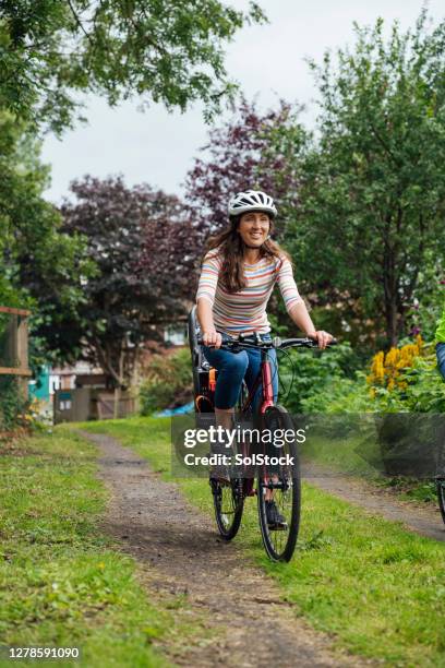 riding through the park - cycling helmet stock pictures, royalty-free photos & images