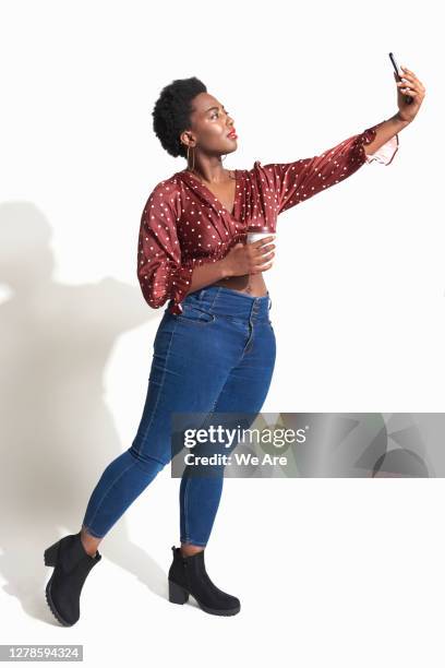 woman taking selfie - taking selfie white background stock-fotos und bilder