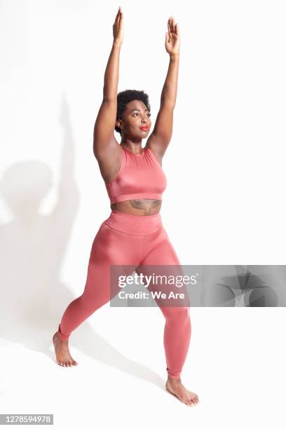 woman in yoga pose - stretching home stock pictures, royalty-free photos & images