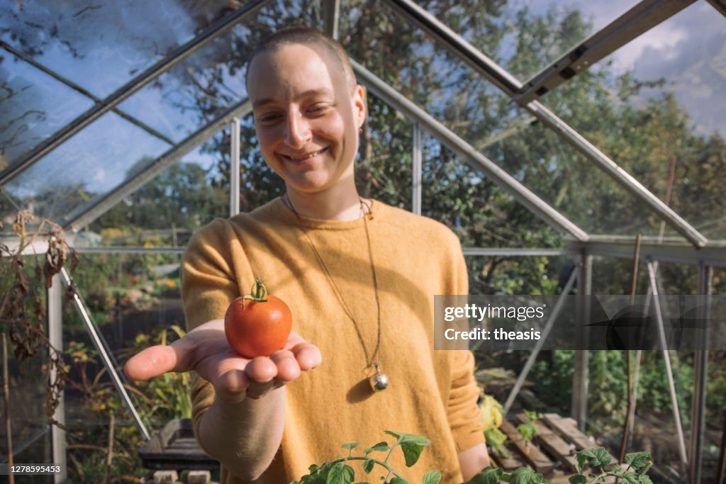 Young woman harvesting vegetables