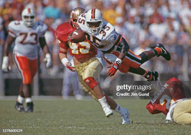 Darryl Spencer, Wide Receiver for the University of Miami Hurricanes in mid air with the ball during the NCAA Big East Conference college football...