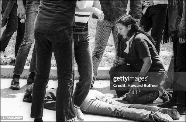 Teenager Mary Ann Vecchio kneels over the body of Kent State University student Jeffrey Miller who had been shot during an anti-war demonstration on...
