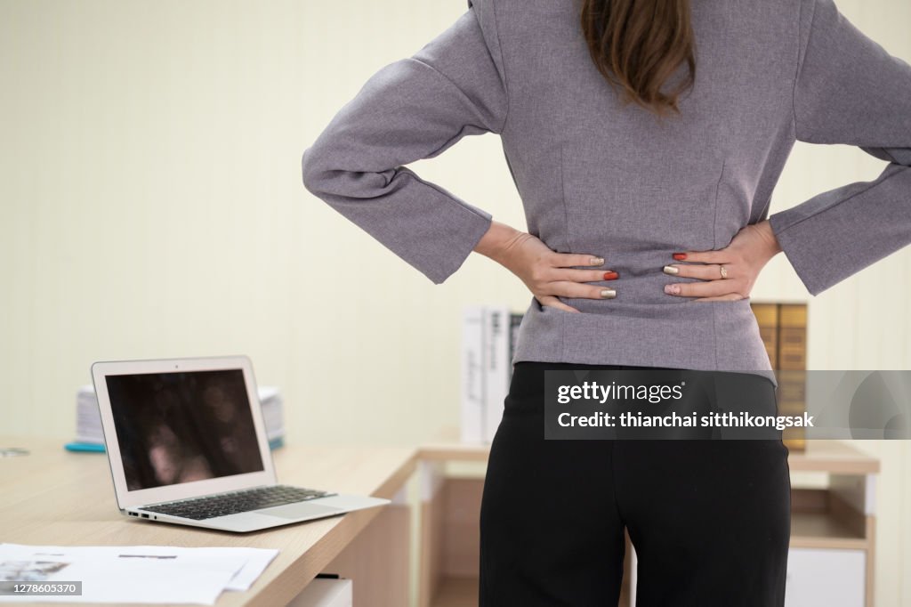 Office syndrome concept.Businesswoman backache or spinal spasm in the office.