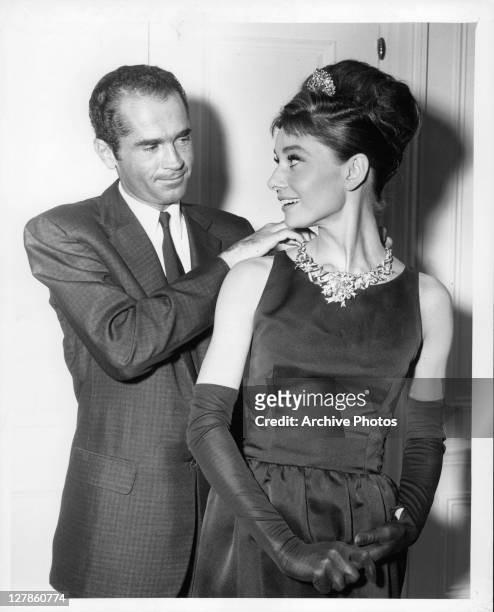 Henry B Platt, great-grandson of the founder of Tiffany's, adjusts Audrey Hepburn's necklace to signal the start of production for the film...