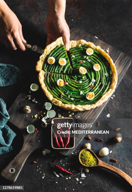 green beans salty tart wirh pesto and red chili with quail eggs - cutting cake stock pictures, royalty-free photos & images