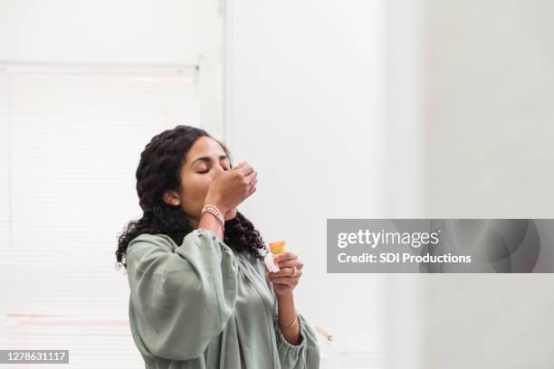 alone in home, woman takes pills - prozac stock pictures, royalty-free photos & images