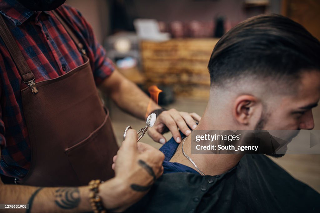 Man Getting Hair Removal By Male Hairdresser With Flame At Barbershop  High-Res Stock Photo - Getty Images
