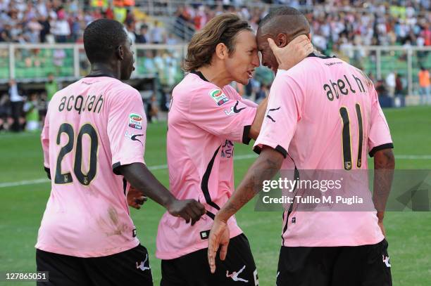 Abel Hernandez of Palermo is congratulated by team-mate Edgar Barreto and Afriyie Acquah after scoring a penalty during the Serie A match between US...