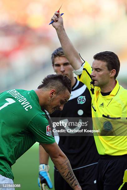 Referee Guido Winkmann shows the red card to Marko Arnautovic of Bremen during the Bundesliga match between Hanover 96 and SV Werder Bremen at AWD...