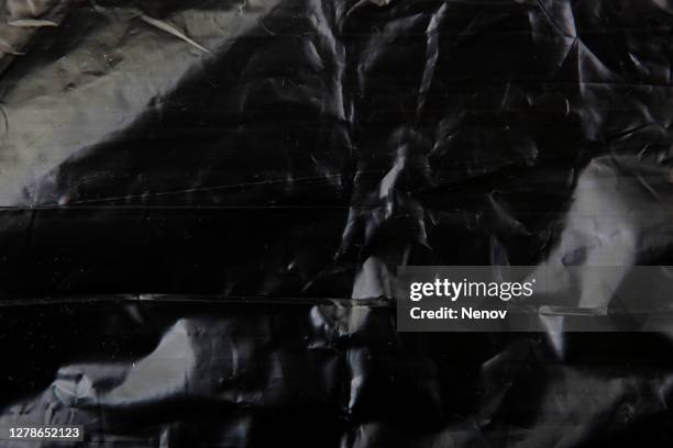 image of black polyethylene texture - folie verpackung stock-fotos und bilder