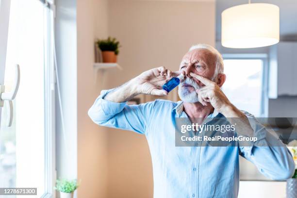 man dripping nasal drops - nozes stock pictures, royalty-free photos & images