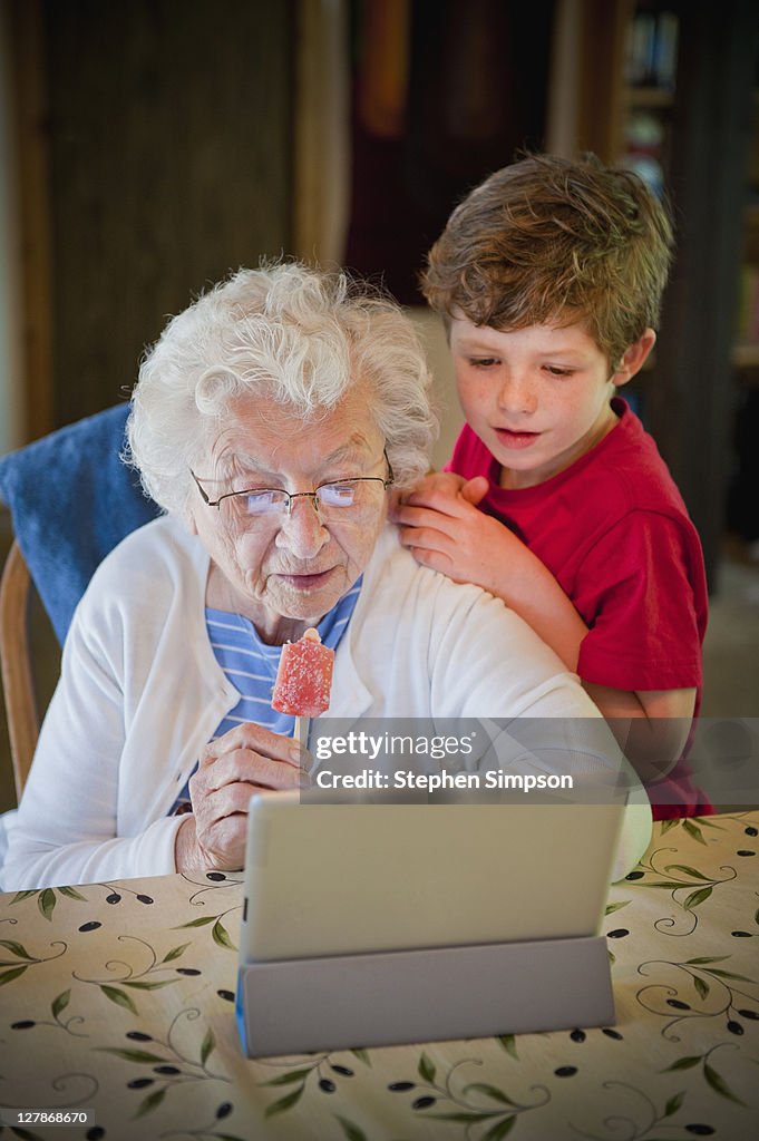 Grandma & grandson exploring her tablet computer