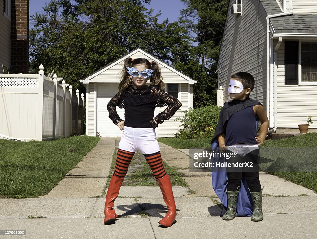 2 kids in costumes and masks