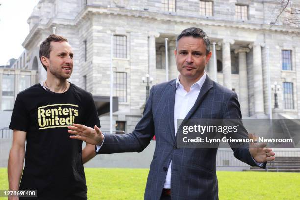 Green Party Co-Leader James Shaw, watched by Aaron Packard of the tenants' rights pressure group Renters United, speaks to protesters in front of...