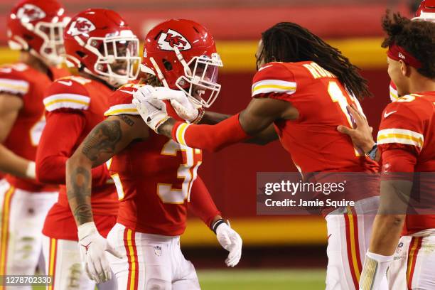 Tyrann Mathieu of the Kansas City Chiefs celebrates with teammates after scoring a pick six in the fourth quarter against the New England Patriots at...