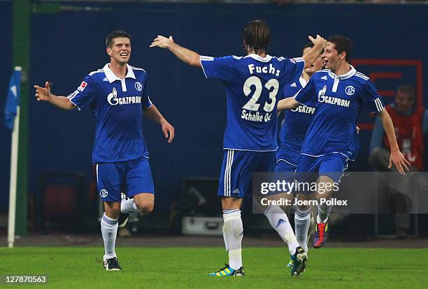 Klaas-Jan Huntelaar of Schalke celebrates with his team mates after scoring his team's second goal during the Bundesliga match between Hamburger SV...