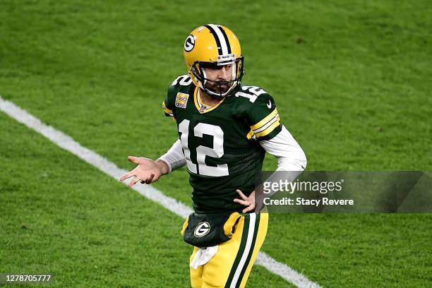 Aaron Rodgers of the Green Bay Packers reacts after throwing a touchdown pass to Robert Tonyan during the second quarter against the Atlanta Falcons...