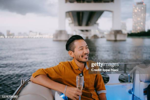 japanese man having a good time on boat, tokyo bay - 40代 男性 ストックフォトと画��像