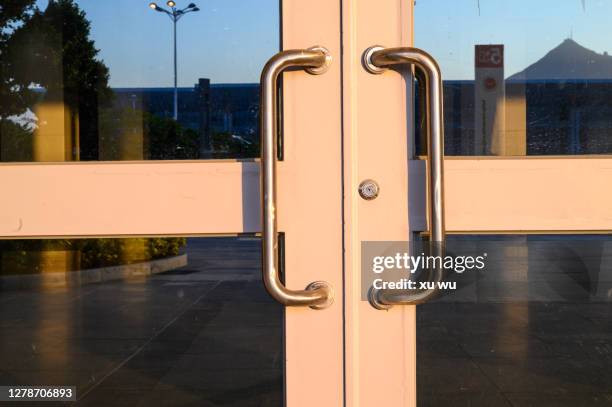 glass door at the entrance of the building exterior - sliding door stock pictures, royalty-free photos & images