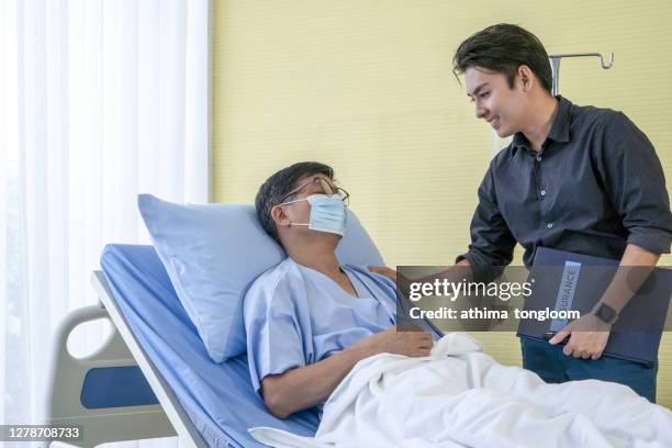 an elderly with insurance advisor - genital herpes foto e immagini stock