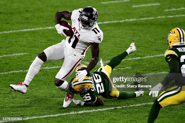 Darnell Savage of the Green Bay Packers attempts to tackle Julio Jones of the Atlanta Falcons during the first half at Lambeau Field on October 05,...