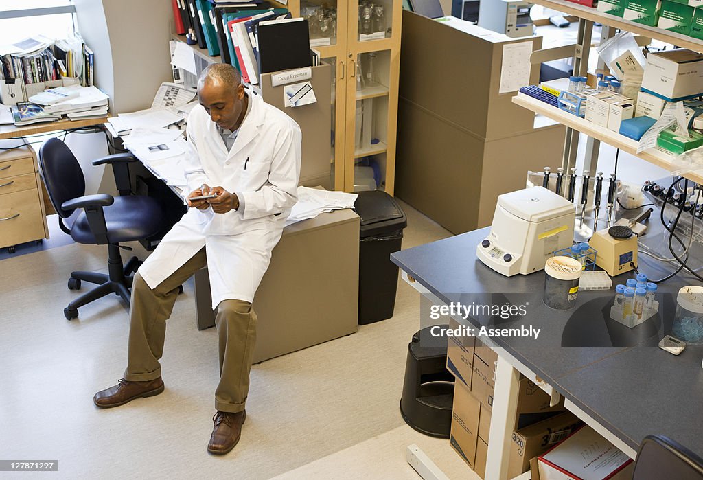 Laboratory Technician Texting On His Cell Phone High-Res Stock Photo ...